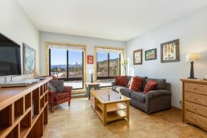ein Wohnzimmer mit Sofa und Fernseher in der Unterkunft 2754 Slopeside condo in Keystone