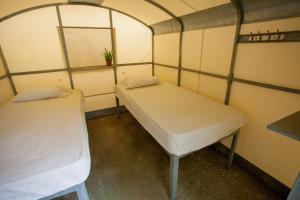 a couple of beds in a small room at Camping Koula in Parikia
