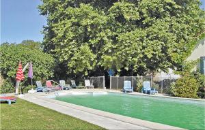 a swimming pool with lounge chairs and a tree at Nice Home In Cresse With Kitchen in Cressé