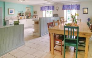 a kitchen and dining room with a wooden table and chairs at Nice Home In Cresse With Kitchen in Cressé