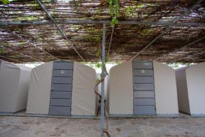 two servers in a room with a ceiling at Camping Koula in Parikia