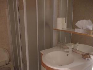 a bathroom with a white sink and a toilet at L'Oursin in Saint-Jean-Cap-Ferrat