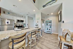 a kitchen with a counter and bar stools at Bayhouse condos 2410 in Rockport