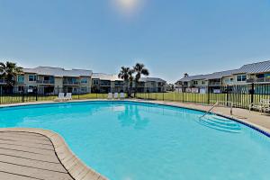 a large swimming pool in front of some apartment complexes at Bayhouse condos 2410 in Rockport