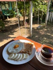 a plate of food with an egg and bread on a table at Pai Modern House in Pai