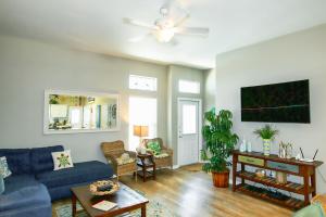 a living room with a blue couch and a ceiling fan at Crab Shack in Corpus Christi