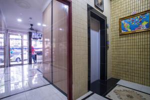 a hallway with a glass door in a building at MK Inn Hotel in Kuala Lumpur