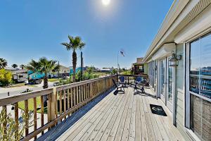 a wooden deck with a bench on a house at Festive Beach Retreat in Rockport