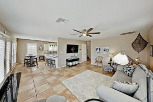 a living room with a couch and a ceiling fan at Festive Beach Retreat in Rockport