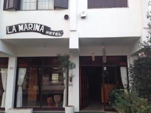 a building with a sign that reads la mariana hotel at Hotel La Marina in Villa Carlos Paz