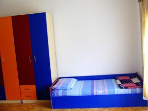 a bedroom with a blue bed and a cabinet at Hostel Domestika in Bitola