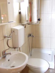 a small bathroom with a toilet and a sink at Hostel Domestika in Bitola