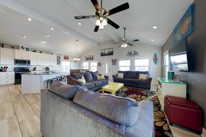 a living room with two couches and a kitchen at Beautiful Sea in Port Aransas
