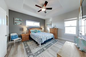 a bedroom with a bed and a ceiling fan at Beautiful Sea in Port Aransas