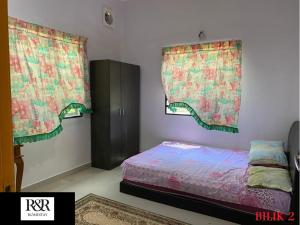 Postel nebo postele na pokoji v ubytování R & R HOMESTAY