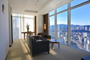 a living room with a view of a city at Ecograd Hotel in Suncheon