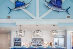 a kitchen with two fish hanging from the ceiling at Big Blue at Palmilla Beach in Port Aransas