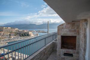 a balcony with a fireplace and a view of the ocean at Mare Fuori in Portoferraio