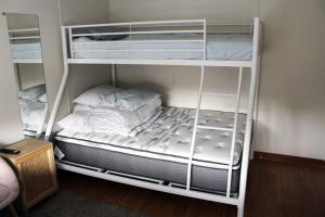 a couple of bunk beds in a room at Investigator Beach Breeze Apartments U2 in Kingscote