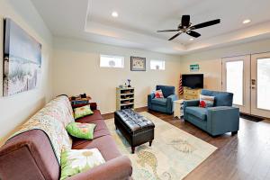 a living room with a couch and two chairs at South Pearl Sailfish in Rockport