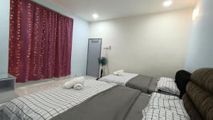 a bedroom with two beds and a red curtain at Party/Gathering Semi-D House @Nusajaya Skudai Johor By Popeye Homestay in Skudai