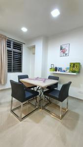 a dining room with a table and two chairs at Party/Gathering Semi-D House @Nusajaya Skudai Johor By Popeye Homestay in Skudai