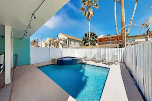 a swimming pool in the backyard of a house at Island Escape & Huisache Townhome in South Padre Island