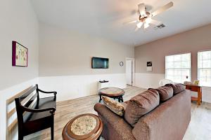 a living room with a couch and a ceiling fan at Simply Relax in Rockport