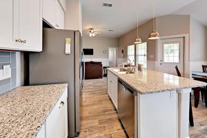 a kitchen with a refrigerator and a counter top at Simply Relax in Rockport