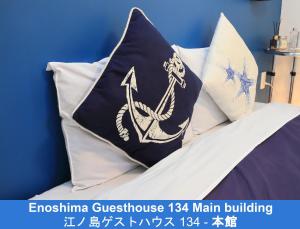 a pillow with an anchor on it sitting on a bed at Enoshima Guest House 134 in Fujisawa