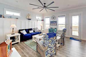 a living room with a blue couch and chairs at Nelson Gem in Port Bolivar