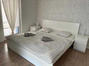 a bedroom with a white bed with two pillows on it at Apartmán v centre Michaloviec in Michalovce