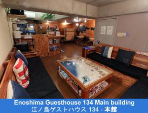 a living room with a couch and a table at Enoshima Guest House 134 in Fujisawa