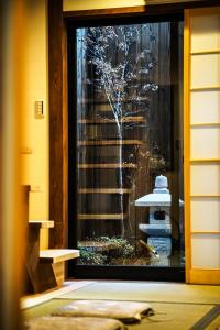 a window of a building with a tree outside at INN Plus Toji Fushin in Kyoto