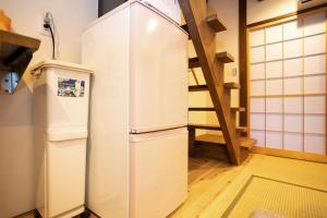 a white refrigerator in a kitchen with a staircase at INN Plus Toji Fushin in Kyoto