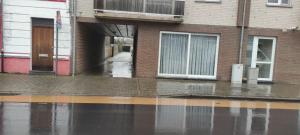 a flooded street in front of a building at loft appartement met 3 slaapkamers en gratis parking in Ichtegem +13 photos
