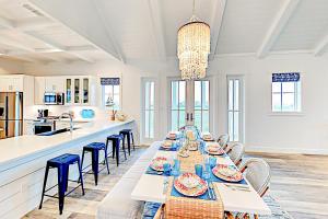 a dining room with a long table and chairs at Golf Course Living at Palmilla Beach in Port Aransas