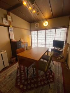 a dining room with a wooden table and chairs at HAKUBA Raicho Star in Hakuba