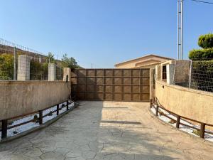 a wooden fence next to a walkway in a yard at mood house in Kos Town