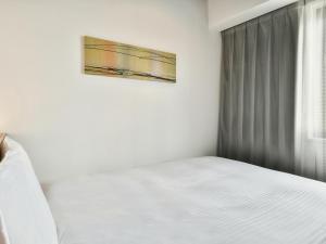 Postel nebo postele na pokoji v ubytování VESSEL INN NAMBA