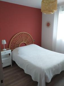 a bedroom with a white bed and a red wall at Fan 36B in La Roche-de-Glun