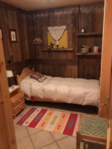 1 Schlafzimmer mit 2 Betten in einem Zimmer mit Holzwänden in der Unterkunft Fiocco di neve in Pila