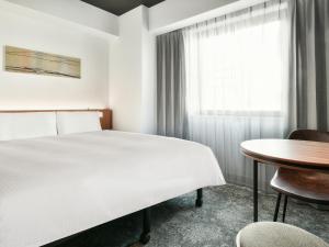 Postel nebo postele na pokoji v ubytování VESSEL INN NAMBA