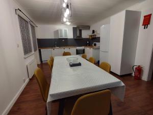 a kitchen with a table and chairs in a room at Villa Stolle in Hammarstrand