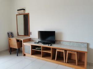 a living room with a television on a table at Gold Coast Morib Resort in Banting