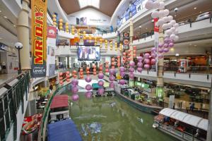 a shopping mall with a river with balloons in it at N HIBISCUS HOTEL in Seri Kembangan