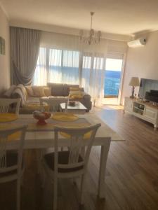 a living room with a table and a couch at Apartment Your Home in Dobra Voda