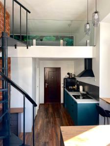 uma cozinha com armários azuis e um loft em Apartment M&A - third floor em Lovran