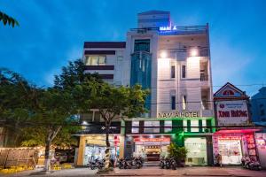 a building with motorcycles parked in front of it at Nam A Hotel - Central City in Da Nang