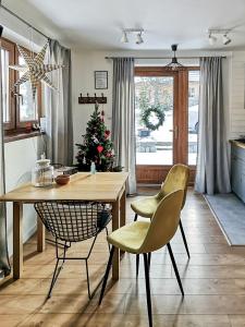uma sala de estar com mesa e cadeiras e uma árvore de Natal em Apartament Gorsky em Poronin